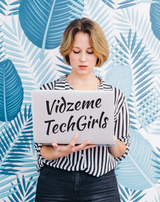 woman-standing-with-laptop-office